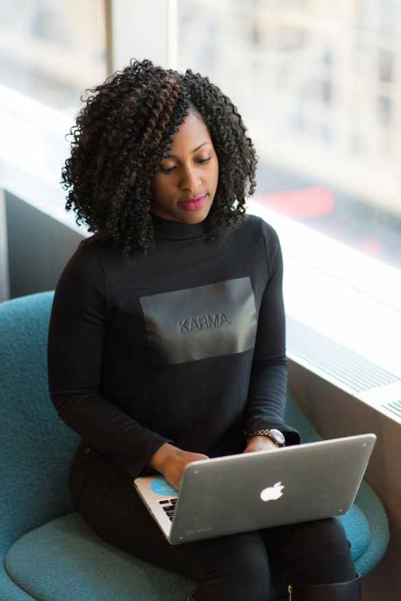 woman in black long sleeved shirt using laptop